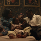 The family from Them reads together on a bed in a screenshot from the series